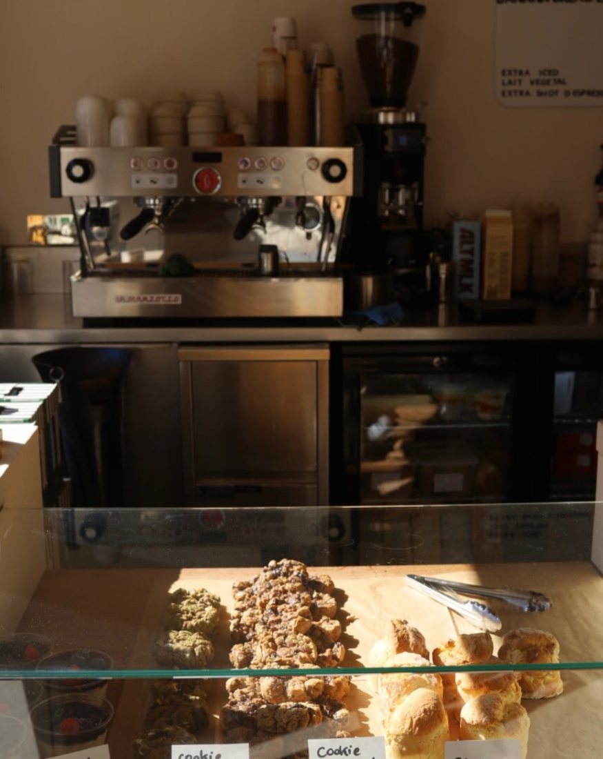 Le comptoir : machine à espresso et vitrine de pâtisseries maison